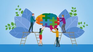 Four people are doing a brain-puzzle together.