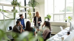 A woman speaks with a group of students